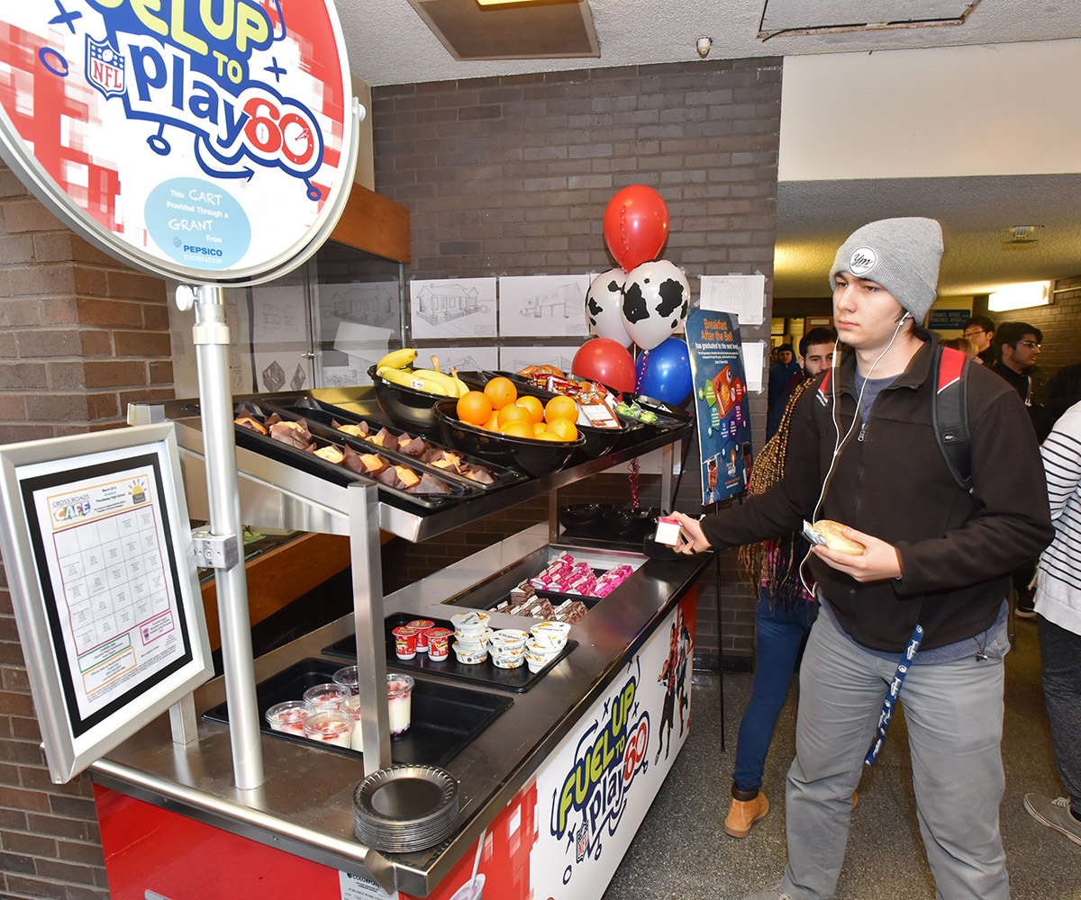2018.03.06 Piscataway NJ Gen Youth PepsiCo Breakfast Event Photos Key shots 008 Young man grabbing a milk carton from a school dairy cart