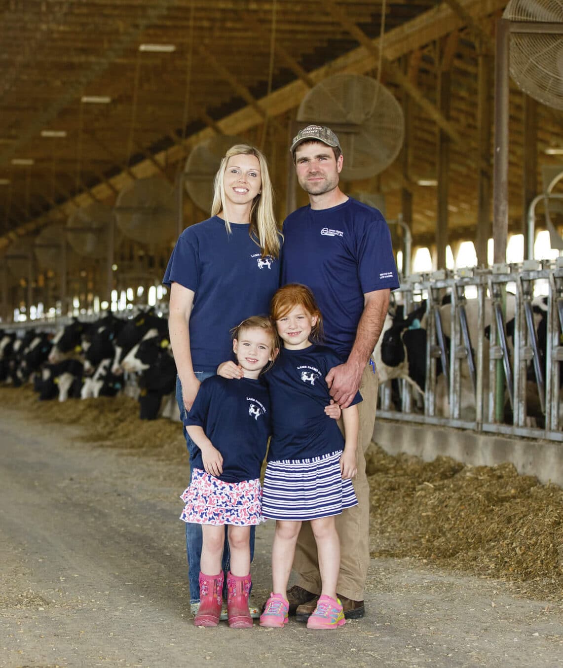 lamb-farms Family posing inside of a barn