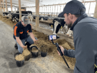 IMG_8813 Man being filmed holding cow feed from pails